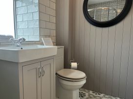 A bathroom with a sink and toilet at The Stables At Cae Gwyn in Ruthin