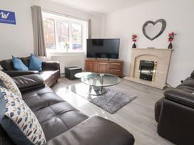 A living room with a television and coffee table at Castellolwg