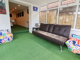 A recreational room with sofa and bean bags at Castellolwg