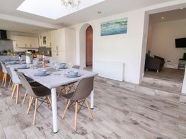 A dining room with a table set for meals at Castellolwg 