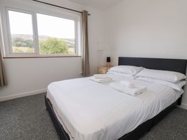 A bedroom with a bed and towels at Castellolwg