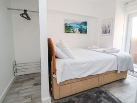 A bedroom with a bed and artwork at Castellolwg