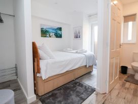 A bedroom with a single bed and an ensuite bathroom at Castellolwg