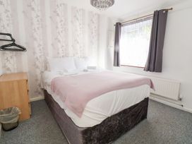 A bedroom with a bed and window at Castellolwg