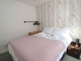 A bedroom with a bed and towels at Castellolwg