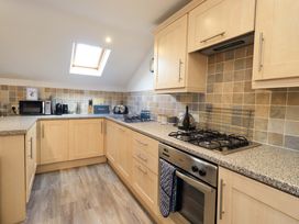 A kitchen with appliances and cabinets at High Dow Crag in Coniston