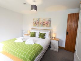 A bedroom with a bed and bedside table at High Dow Crag in Coniston