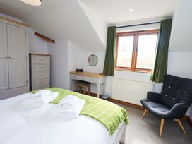 A bedroom with a bed and wardrobe at High Dow Crag in Coniston