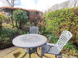 A table and two chairs in a garden at High Dow Crag in Coniston
