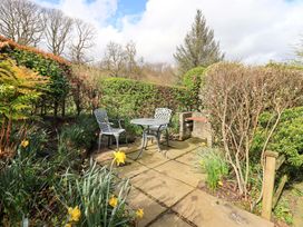 A garden area with a table and chairs at High Dow Crag in Coniston