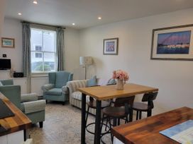A living room with a sofa and armchairs at Millgate Cottage in Conwy