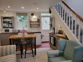 A kitchen with a table and chairs at Millgate Cottage in Conwy