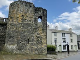 A stone tower and house on street at Millgate Cottage Conwy