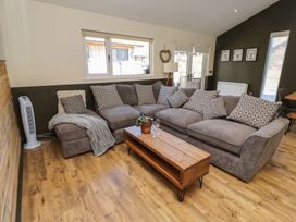 A living room with a sofa and coffee table at Barn Owl in Otterburn