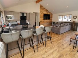 An open plan living area with kitchen and seating at Barn Owl in Otterburn