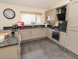 A kitchen with cabinets and appliances at Barn Owl in Otterburn