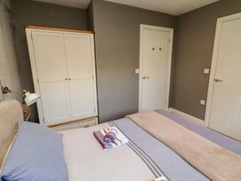 A bedroom with a bed and wardrobe at Barn Owl in Otterburn