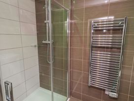 A bathroom with a shower and towel rail at Barn Owl in Otterburn