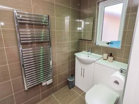 A bathroom featuring a sink, toilet, and a radiator at Barn Owl in Otterburn