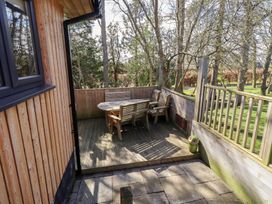 An outdoor patio with a table and chairs at Barn Owl in Otterburn
