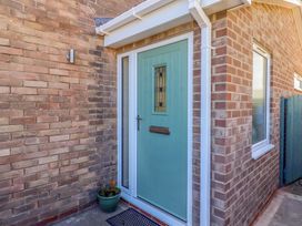 A front entrance with a door and plant pot at The Nest in Beadnell