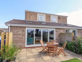 An outdoor area with a table and chairs at The Nest in Beadnell