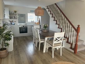 A kitchen and dining area with a table and chairs at The Nest in Beadnell