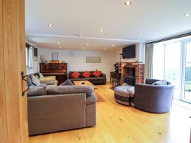 A living room with a piano and fireplace at Bwthyn Y Bugail (Shepherd's Cottage) Pedairffordd near Llanrhaeadr-Ym-Mochnant