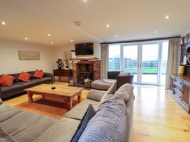 A living room with a coffee table and fireplace at Bwthyn Y Bugail (Shepherd's Cottage) Pedairffordd near Llanrhaeadr-Ym-Mochnant