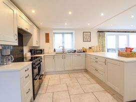 A kitchen with cabinets and appliances at Bwthyn Y Bugail (Shepherd's Cottage) Pedairffordd near Llanrhaeadr-Ym-Mochnant