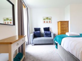 A bedroom with a sofa and chest of drawers at Bwthyn Y Bugail (Shepherd's Cottage) Pedairffordd near Llanrhaeadr-Ym-Mochnant