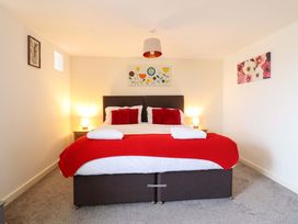 A bedroom with a bed and two bedside tables at Bwthyn Y Bugail (Shepherd's Cottage) Pedairffordd near Llanrhaeadr-Ym-Mochnant