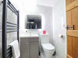 A bathroom with a sink, toilet, and towel rail at Bwthyn Y Bugail (Shepherd's Cottage) Pedairffordd near Llanrhaeadr-Ym-Mochnant