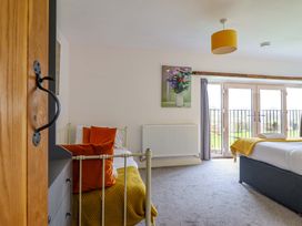 A bedroom with beds and a painting at Bwthyn Y Bugail (Shepherd's Cottage) Pedairffordd near Llanrhaeadr-Ym-Mochnant