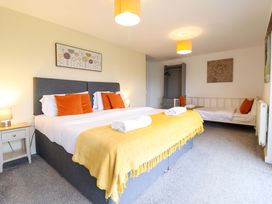 A bedroom with a double bed and additional single bed at Bwthyn Y Bugail (Shepherd's Cottage) Pedairffordd near Llanrhaeadr-Ym-Mochnant