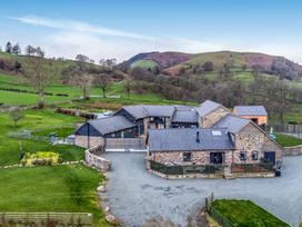A house surrounded by greenery at Bwthyn Y Bugail (Shepherd's Cottage) Pedairffordd near Llanrhaeadr-Ym-Mochnant