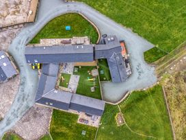 An aerial view of a property with buildings and grass area at Y Beudy (The Dairy) Pedairffordd near Llanrhaeadr-Ym-Mochnant