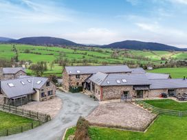 An aerial view of buildings and fields at Y Granar (The Granary) Llanrhaeadr-Ym-Mochnant