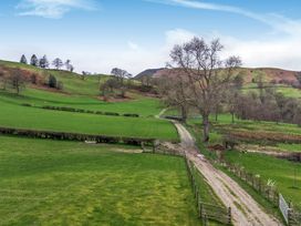 A landscape with green fields and a winding path at Y Stabl (The Stable) Llanrhaeadr-Ym-Mochnant