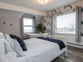 A bedroom with a bed and bathtub at The Wren Llysfaen