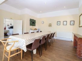 A dining room with a long table and chairs at Sunnymeade in Buxton, Norfolk