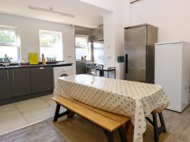 A kitchen with a table and benches at Sunnymeade, Buxton, Norfolk