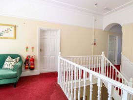 A hallway with a green sofa and a picture frame at Sunnymeade Buxton, Norfolk