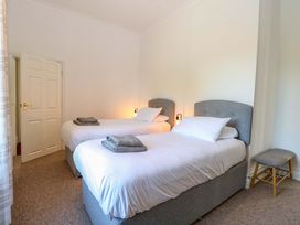 A bedroom with two single beds and a chair at Sunnymeade Buxton, Norfolk