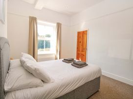A bedroom with a bed and towels on top at Sunnymeade in Buxton, Norfolk