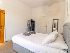 A bedroom with a bed and towels on top at Sunnymeade in Buxton, Norfolk