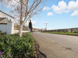 A street with trees and hedges at Kingfisher Corner in Little Kelk near Bridlington