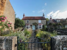 A house with a garden and pathway at Bute Cottage Lockton near Pickering