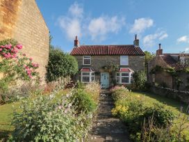 A house with a garden and pathway at Bute Cottage in Lockton near Pickering