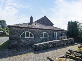 An outdoor view of a house with a patio at Windermere at the Graythwaite Estate near Hawkshead